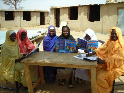 Young Darfuri women studying their new English books, donated by Book Wish Foundation
